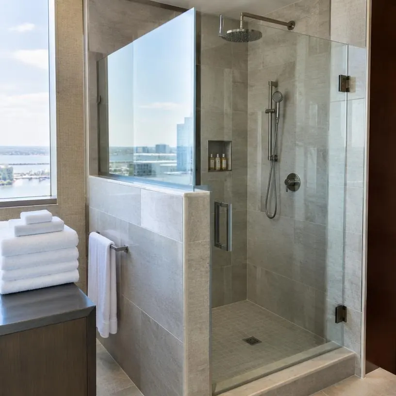 Hotel shower with partial glass door